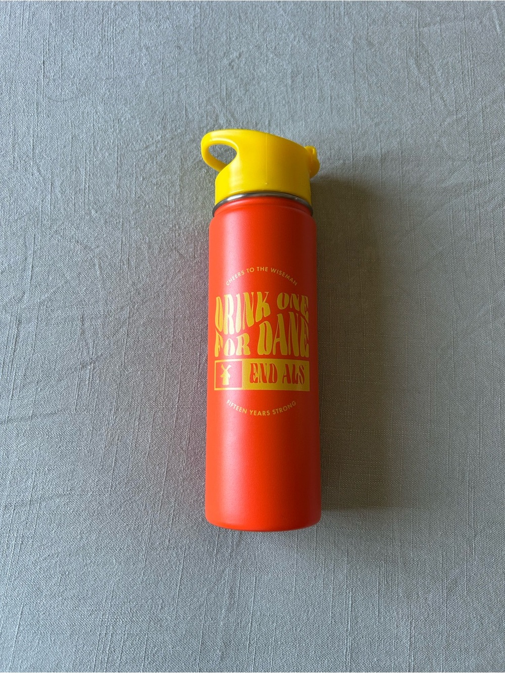 Dutch Bros Orange Bottle with Yellow Cap and Graphic